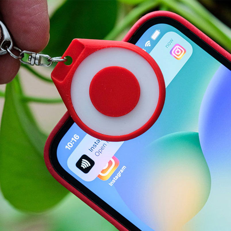 Red TapTag sharing an Instagram link with a phone