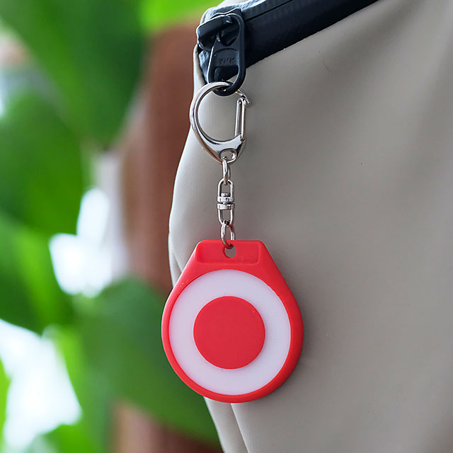 Red TapTag clipped to a bag